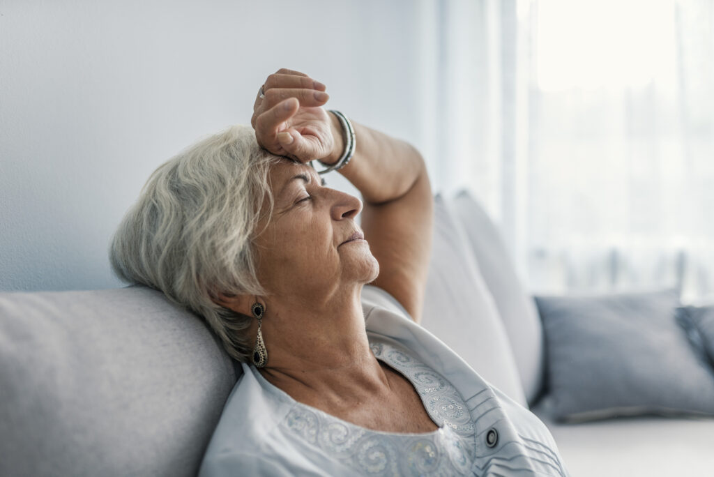 Tired senior woman experiencing extreme fatigue.
