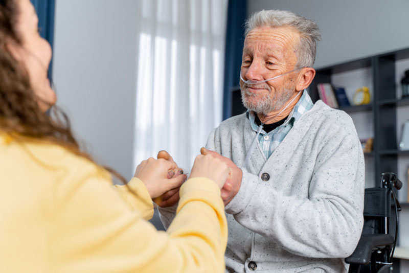 A woman provides COPD care at home for her aging father.